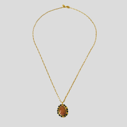 Gold necklace with a pendant on a white background