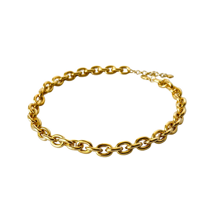 Gold chain bracelet on a light gray background