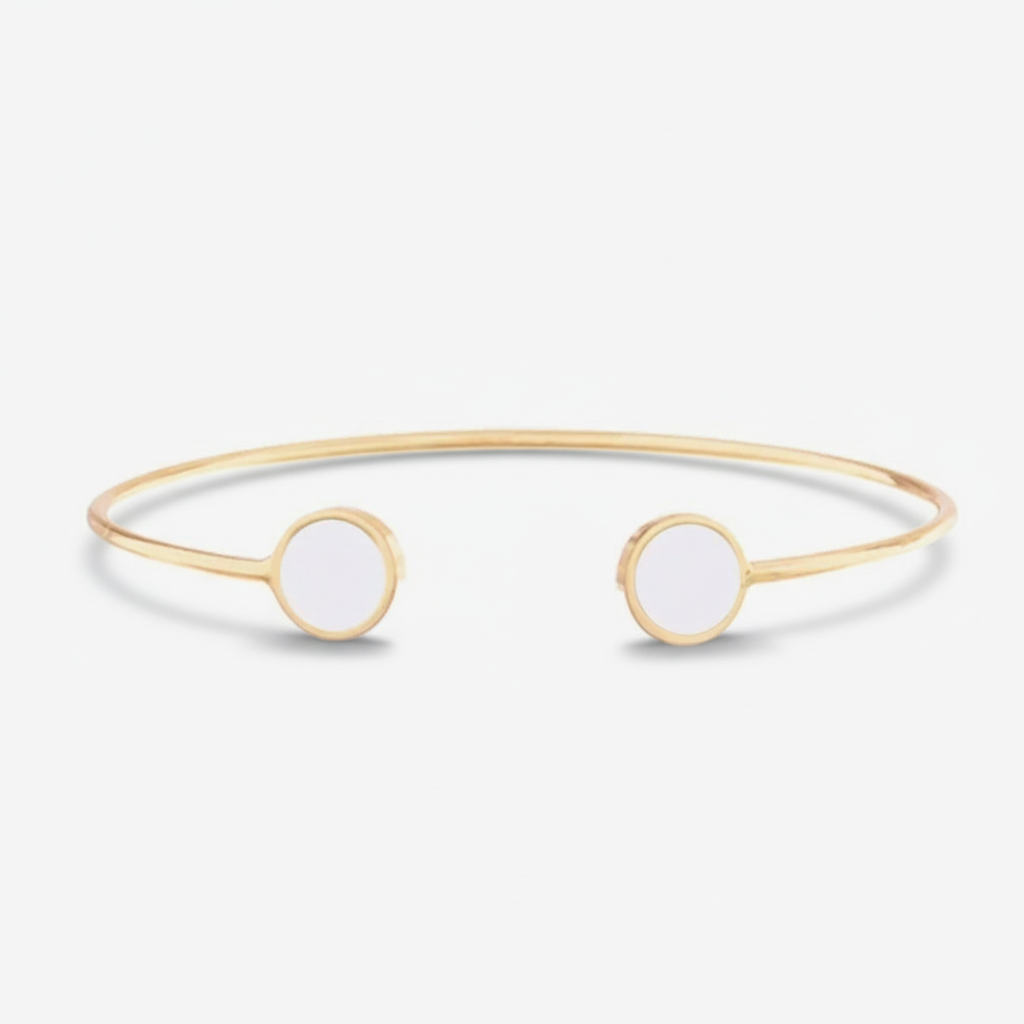 Gold bangle with white stones on a white background