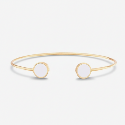 Gold bangle with white stones on a white background